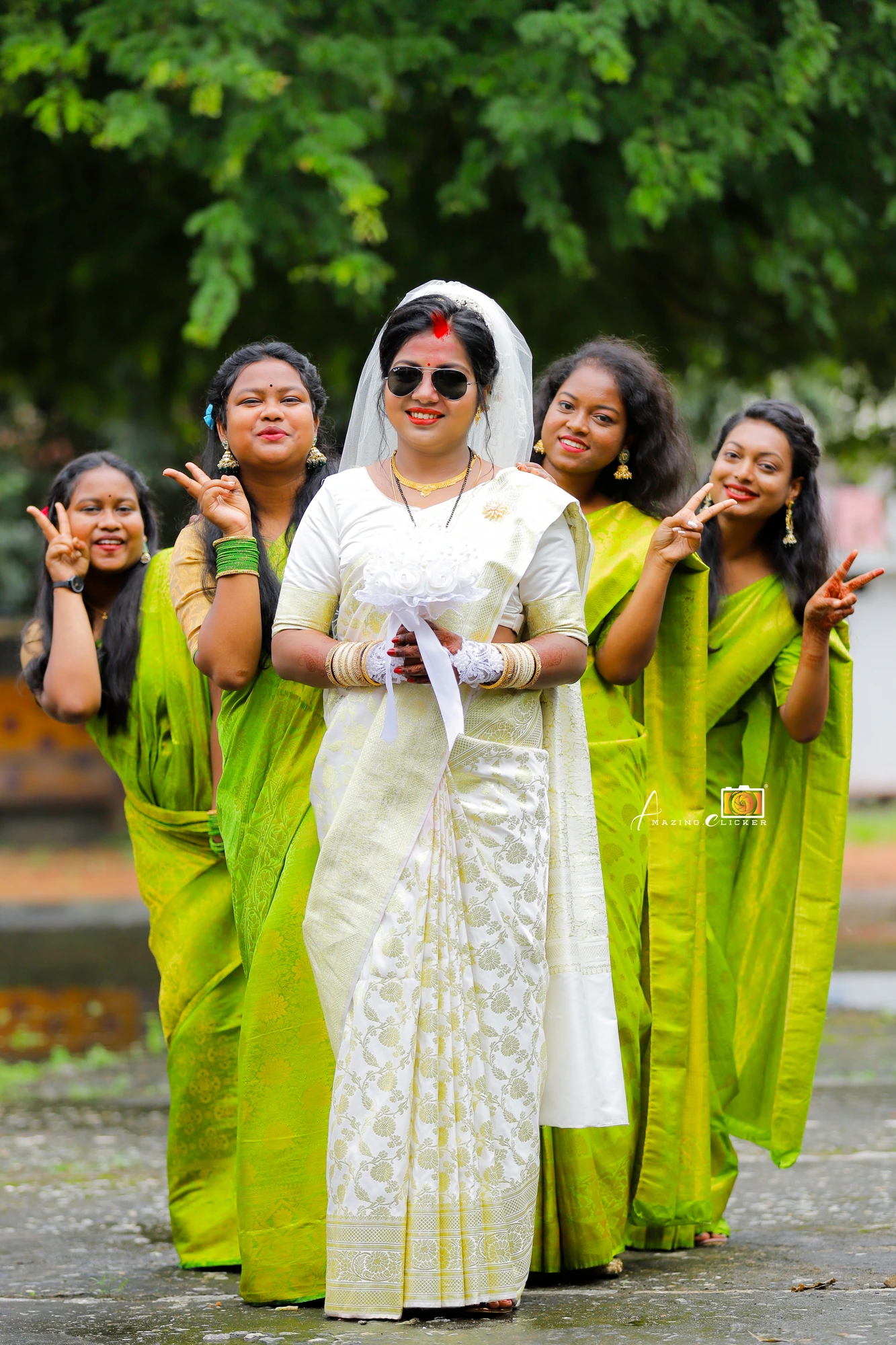 Bride with her bridesmaids in green sarees